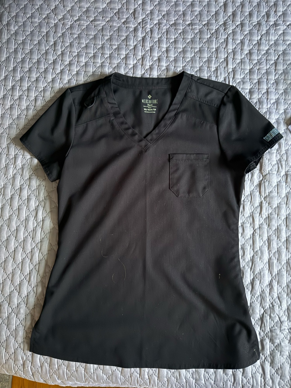 Med Couture Touch woman’s Black V-Neck Short Sleeve Scrub Top with Chest Pocket